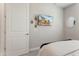 Bright bedroom features a mounted TV, neutral walls, and comfy bed at 21090 N 267Th Dr, Buckeye, AZ 85396