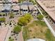 Aerial view of new construction homes surrounding landscaped greenbelt with trees and shrubs at 21090 N 267Th Dr, Buckeye, AZ 85396