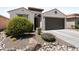 Well-maintained front yard with desert landscaping, decorative rocks, and a charming exterior at 21090 N 267Th Dr, Buckeye, AZ 85396