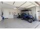 Spacious garage with epoxy floors, golf cart, and ample storage at 21090 N 267Th Dr, Buckeye, AZ 85396