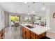 Bright open kitchen with white countertops, island with sink, and open flow to dining area at 21090 N 267Th Dr, Buckeye, AZ 85396