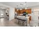 Modern kitchen featuring an island with seating, stainless steel appliances, and ample cabinet space at 21090 N 267Th Dr, Buckeye, AZ 85396