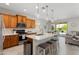 Modern kitchen featuring wood cabinets, stainless steel appliances, and an island with seating at 21090 N 267Th Dr, Buckeye, AZ 85396