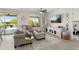 Cozy living room featuring a sectional sofa, ceiling fan, TV, and an adjacent backyard view at 21090 N 267Th Dr, Buckeye, AZ 85396