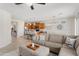 Open-concept living area with a view of the kitchen, a comfortable sofa, and modern decor at 21090 N 267Th Dr, Buckeye, AZ 85396