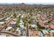 Neighborhood aerial view highlighting orderly streets, various home styles and sparkling swimming pools against a mountain backdrop at 211 W Braeburn Dr, Phoenix, AZ 85023