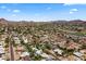 Sweeping aerial of a vibrant residential neighborhood showcasing numerous homes and lush landscaping with mountain views at 211 W Braeburn Dr, Phoenix, AZ 85023