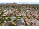 An aerial view of a neighborhood highlighting the lush greenery, neighborhood streets and nearby mountains at 211 W Braeburn Dr, Phoenix, AZ 85023