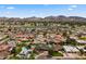 Expansive aerial view of a neighborhood with houses, swimming pools, and mountain views against a clear blue sky at 211 W Braeburn Dr, Phoenix, AZ 85023