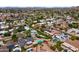 An aerial view of a neighborhood highlighting the lush greenery, neighborhood streets and nearby mountains at 211 W Braeburn Dr, Phoenix, AZ 85023