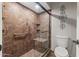 Updated bathroom features glass enclosed tile shower, grab bar, and a decorative wall hanging at 211 W Braeburn Dr, Phoenix, AZ 85023
