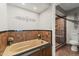 Elegant bathroom with soaker tub, decorative accents, and glass enclosed tile shower at 211 W Braeburn Dr, Phoenix, AZ 85023