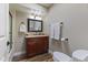 Bathroom featuring a dark wood vanity with granite countertop, and wood-look tile flooring at 211 W Braeburn Dr, Phoenix, AZ 85023