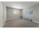 Neutral bedroom featuring carpet floors, ample natural light, and closet at 211 W Braeburn Dr, Phoenix, AZ 85023