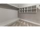 Walk-in closet with carpet and multiple built-in shelves and rails for ample storage at 211 W Braeburn Dr, Phoenix, AZ 85023