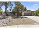 Front view of a single-Gathering home featuring a stone facade, neutral paint, desert landscaping, and a two car garage at 211 W Braeburn Dr, Phoenix, AZ 85023