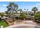 Charming single-story home features a stone facade, mature landscaping, and a well-manicured front yard with palm trees at 211 W Braeburn Dr, Phoenix, AZ 85023