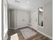 Bright foyer featuring wood-look tile floors, a decorative rug, and a sunlit window, enhancing the home's appeal at 211 W Braeburn Dr, Phoenix, AZ 85023