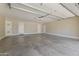 Spacious three car garage featuring a concrete floor, white walls, and updated garage door at 211 W Braeburn Dr, Phoenix, AZ 85023