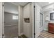 Hallway featuring a storage cabinet and bathroom with a shower/tub combo at 211 W Braeburn Dr, Phoenix, AZ 85023