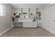Bright home office with built-in desk, shelving, storage, and neutral carpet at 211 W Braeburn Dr, Phoenix, AZ 85023