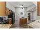 Kitchen features stylish wood cabinets, granite countertops, stainless appliances, and center island with breakfast bar at 211 W Braeburn Dr, Phoenix, AZ 85023