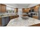 Well-equipped kitchen with granite countertops, wood cabinets, and modern appliances, offering style and functionality at 211 W Braeburn Dr, Phoenix, AZ 85023