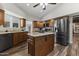 Open kitchen featuring wood cabinets, granite countertops, an island, and stainless steel appliances at 211 W Braeburn Dr, Phoenix, AZ 85023