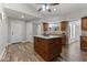 Beautiful kitchen featuring wood-look floors, wooden cabinets, a granite topped island, and stainless appliances at 211 W Braeburn Dr, Phoenix, AZ 85023