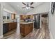 Open kitchen concept with a center island, stainless steel appliances, granite countertops, and wood look tile floor at 211 W Braeburn Dr, Phoenix, AZ 85023