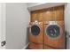 Convenient laundry room with front loading washer/dryer, and lots of storage above the appliances at 211 W Braeburn Dr, Phoenix, AZ 85023