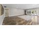 Spacious living room featuring wood-look tile flooring, light walls, and glass patio doors at 211 W Braeburn Dr, Phoenix, AZ 85023