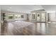 Spacious living room with wood-look floors, multiple windows offering abundant light, and neutral paint at 211 W Braeburn Dr, Phoenix, AZ 85023