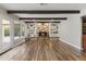 Open living room with hardwood floors, stone fireplace with built-in shelving, and large windows at 211 W Braeburn Dr, Phoenix, AZ 85023
