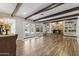 Bright living room with hardwood floors, beams, a stone fireplace, and built-in shelves at 211 W Braeburn Dr, Phoenix, AZ 85023