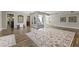 Spacious living room features wood floors, neutral walls and cozy seating near sunroom at 211 W Braeburn Dr, Phoenix, AZ 85023