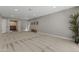 Neutral carpeted living room features light gray walls, recessed lights, and adjacent room at 211 W Braeburn Dr, Phoenix, AZ 85023