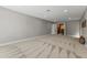 Neutral carpeted living room features light gray walls, recessed lights, and door to another room at 211 W Braeburn Dr, Phoenix, AZ 85023