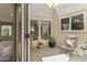 Cozy outdoor patio with brick flooring, comfortable seating, and natural lighting, enhancing the home's appeal at 211 W Braeburn Dr, Phoenix, AZ 85023