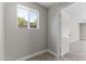 A bonus room featuring natural lighting from a window and grey paint at 211 W Braeburn Dr, Phoenix, AZ 85023
