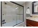 Bathroom featuring a shower/tub combo with glass doors, and granite vanity at 211 W Braeburn Dr, Phoenix, AZ 85023