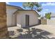 Exterior view of storage shed with gravel landscaping and gated area at 211 W Braeburn Dr, Phoenix, AZ 85023