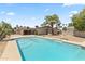 Lovely swimming pool in backyard surrounded by mature trees and desert landscaping at 211 W Braeburn Dr, Phoenix, AZ 85023