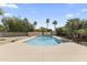 Refreshing swimming pool surrounded by mature trees and desert landscaping at 211 W Braeburn Dr, Phoenix, AZ 85023