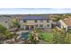 Aerial view shows backyard featuring a pool with waterfall, putting green, patio, and solar panels at 21337 E Waverly Dr, Queen Creek, AZ 85142