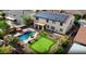 Aerial view showcases a home with solar panels, complemented by a putting green and a pool in the backyard at 21337 E Waverly Dr, Queen Creek, AZ 85142