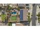 Aerial view of backyard with pool, putting green, patio, and solar panels on the house roof at 21337 E Waverly Dr, Queen Creek, AZ 85142