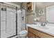 Bathroom featuring glass enclosed shower, neutral cabinets, white sink, and decorative nautical accents at 21337 E Waverly Dr, Queen Creek, AZ 85142