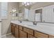 Double sink bathroom with new fixtures, mirrors, and lots of vanity storage space and bright lighting at 21337 E Waverly Dr, Queen Creek, AZ 85142