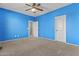 Spacious bedroom featuring a ceiling fan and a door to a walk-in closet, providing ample space and convenience at 21337 E Waverly Dr, Queen Creek, AZ 85142
